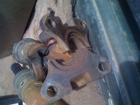 1992 Ford Bronco - This is a close-up of a damaged driveshaft universal joint, likely removed from a vehicle for repair.