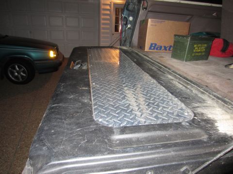 1992 Ford Bronco - A diamond plate cover is installed on a truck bed, with a green sedan parked nearby.