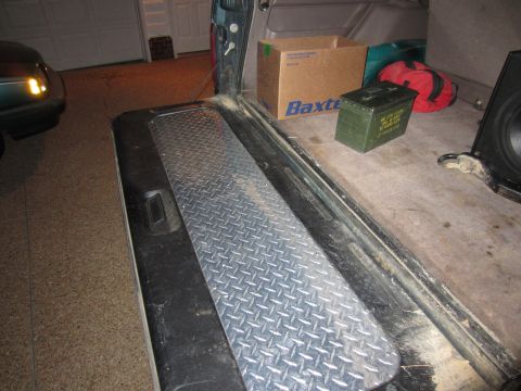 1992 Ford Bronco - View of the cargo area of a vehicle, diamond plate trim and various items including a box and an ammo can.