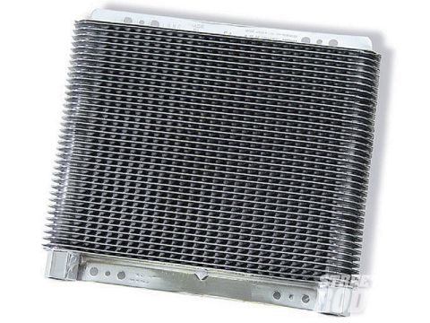 1990 Ford Bronco - This is a transmission cooler, likely an aftermarket part, with visible fins and mounting holes.