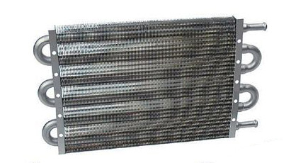 1990 Ford Bronco - A metal component with many fins and tubes, likely for heat exchange.