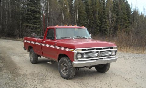 1978 Ford F-250 - This red pickup truck features a distinctive chrome grille and dual side stripes.