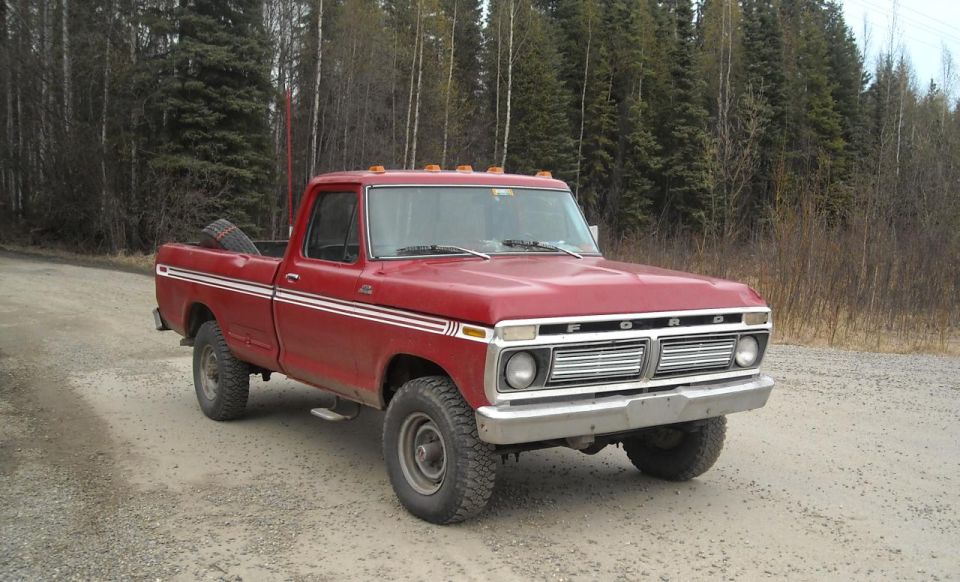 Red pickup truck with chrome grille and side trim