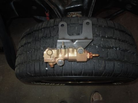 1973 Chevrolet Camaro - Master cylinder brake part shown mounted on a tire, likely for storage or display.