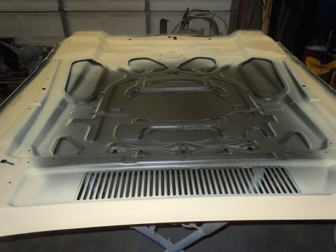 1973 Chevrolet Camaro - The underside of a car hood is visible, showing its internal structure and ventilation grilles.