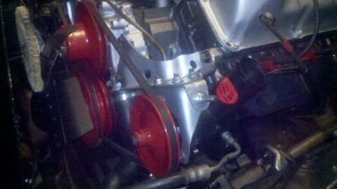 1978 Ford Bronco - Engine components including red pulleys and a drive belt are visible in this close-up shot.