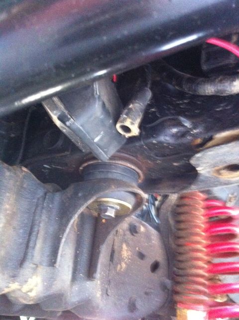 1996 Ford Bronco - Undercarriage view showing suspension components and a red coil spring.