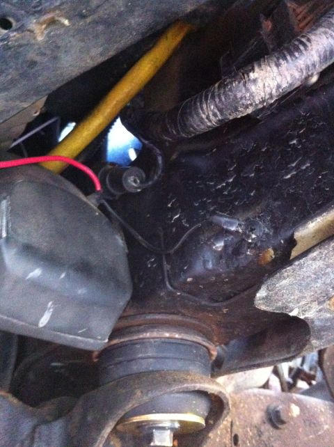 1996 Ford Bronco - Underside view of vehicle suspension components and wiring.