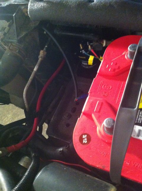 1996 Ford Bronco - Close-up view of dual red-top batteries and associated wiring in an engine bay.