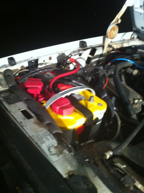 1996 Ford Bronco - The engine bay shows two Optima batteries with red terminal covers and black securing straps.
