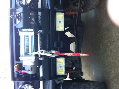 1996 Ford Bronco - A winch and recovery strap are mounted to the vehicle's frame, ready for off-road use.