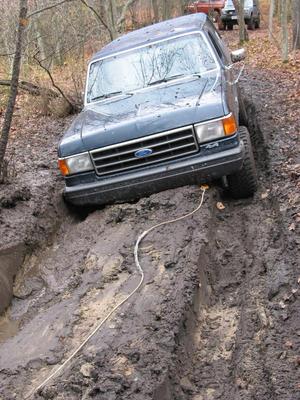 1989 Ford Bronco - Here I am stuck. This was my second pass through the hole. Had to use the snatch block on me and strap the jeep that was winching me to a t…
