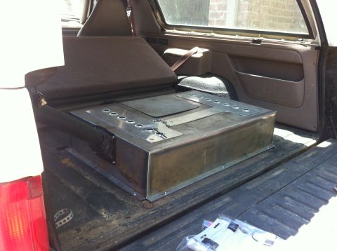 1996 Ford Bronco - Custom fuel tank installation in the rear cargo area of a 1996 Ford Bronco.