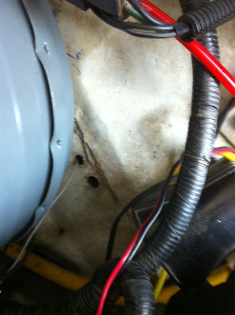 1996 Ford Bronco - Close-up view of wiring and a gray component in a vehicle's engine bay.
