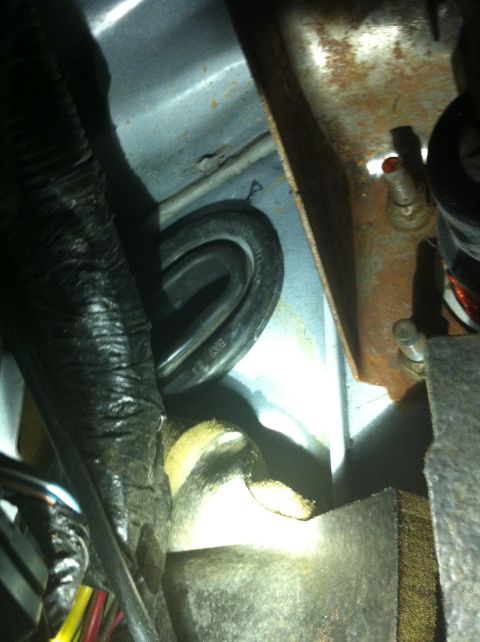 1996 Ford Bronco - Close-up view of wiring and metal components located under the dashboard.