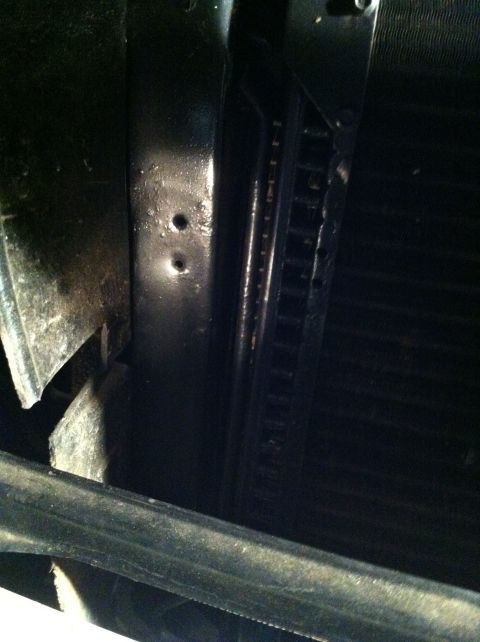 1996 Ford Bronco - Close-up view of a power steering cooler, showing mounting holes and internal fins.