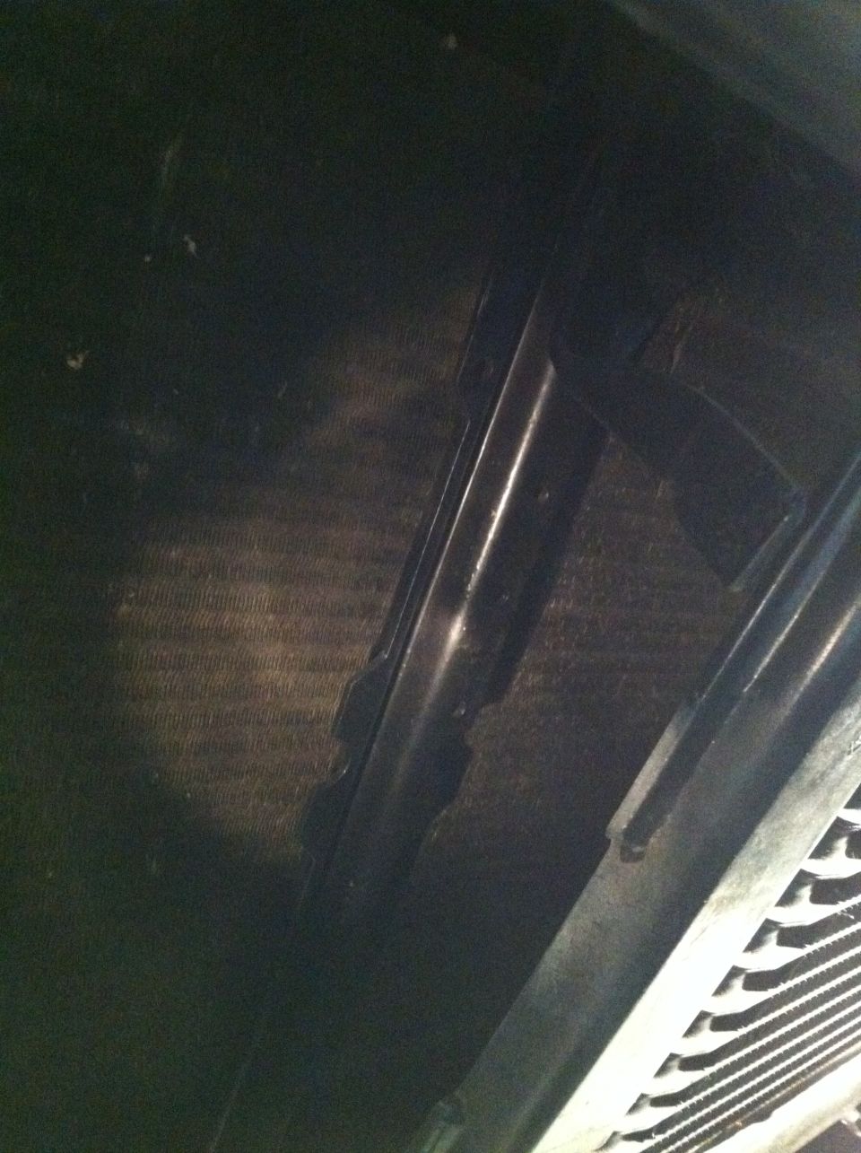 Radiator fins and black plastic fan shroud components