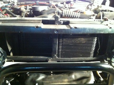 1996 Ford Bronco - Close-up view of the front of a vehicle's engine bay, focusing on the radiator and auxiliary cooler assembly.