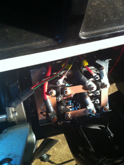 1996 Ford Bronco - Close-up of an exposed winch solenoid pack mounted behind a bumper, showing the copper bus bars, studded terminals and heat-shrunk red and…