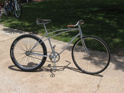 1994 Ford Bronco - A custom cruiser bicycle is parked on a concrete driveway with a grassy lawn in the background.