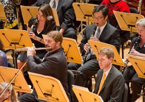 1990 Ford Bronco - An orchestra performs with musicians playing various instruments in a concert hall.