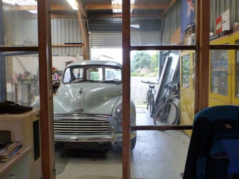 1969 MINI Cooper - A light blue classic car is parked inside a garage, with bicycles visible in the background.