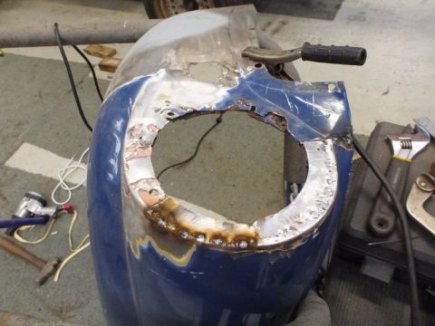 1969 MINI Cooper - Car fender undergoing repair work, showing rust damage and fresh welds.