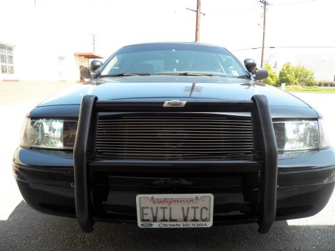 2003 Ford Crown Victoria - Black Ford sedan front showing brush guard, billet grille and California EVIL VIC license plate