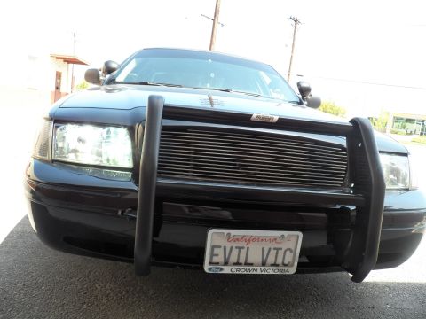 2003 Ford Crown Victoria - Wider front view of black Ford sedan, brush guard and billet grille above EVIL VIC tag