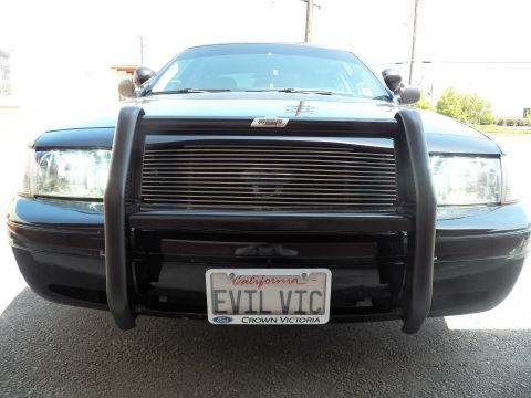 2003 Ford Crown Victoria - Front of dark Ford sedan showing tubular brush guard, billet grille and EVIL VIC tag
