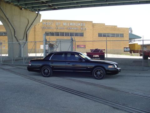 1999 Ford Crown Victoria - A black sedan is parked in front of the Port of Milwaukee General Cargo Terminal.
