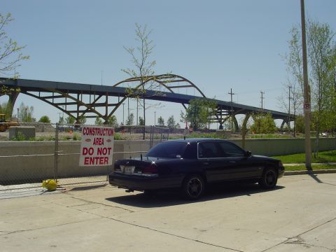 1999 Ford Crown Victoria - A dark 1998 Ford Crown Victoria is parked near a construction area with a bridge overhead.