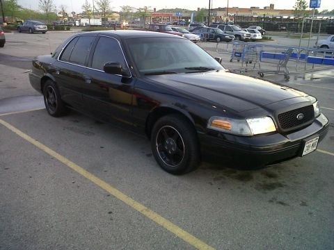 1999 Ford Crown Victoria - This black 1999 Ford Crown Victoria is seen from a three-quarter front view in a parking lot.