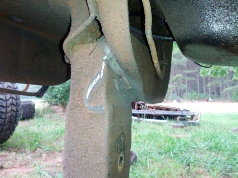 1987 Ford Bronco - This image shows a heavily modified and rusted section of a vehicle's frame and suspension system.