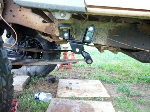 1987 Ford Bronco - Aftermarket suspension components are visible on the underside of a vehicle, suggesting a modification.