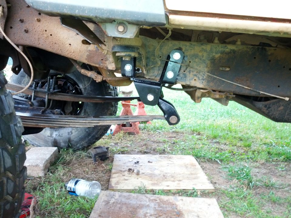 Close-up of aftermarket suspension linkage on a vehicle frame
