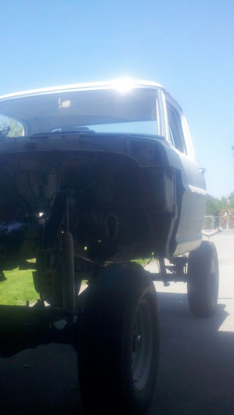 1967 Ford F-250 - Front view of a 1967 Ford F-250 pickup truck chassis undergoing modification with a lifted suspension.