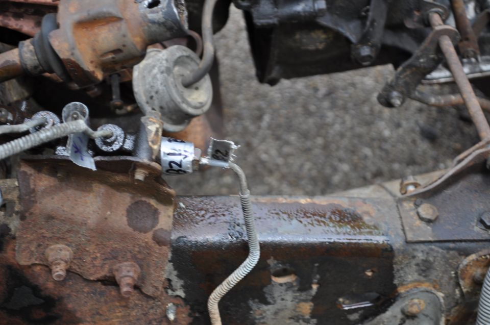 Rusty vehicle chassis with brake line and electrical components. Label reads 'B2'