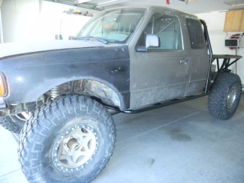 1997 Ford Ranger - This modified Ford Ranger features a custom roll cage and oversized tires, with a mismatched front fender.