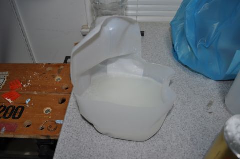 1986 Ford Bronco - A plastic jug filled with a white, foamy liquid sits on a speckled countertop.