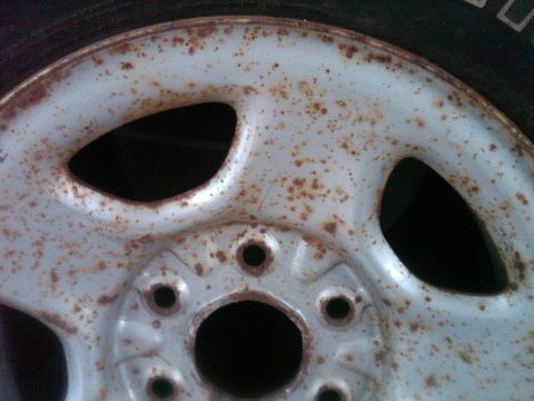 1986 Ford Bronco - Close-up of a heavily rusted wheel, likely needing restoration.