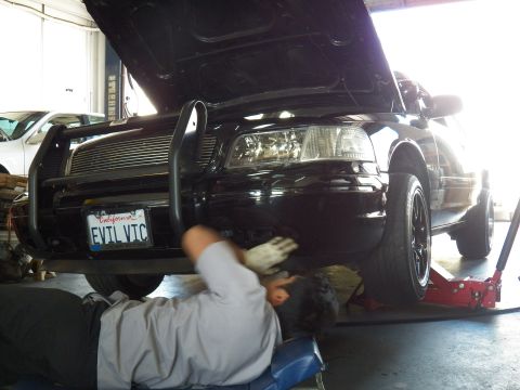 2003 Ford Crown Victoria - Hand blurred in motion at the EVIL VIC Crown Vic front while the car sits on a floor jack, hood open