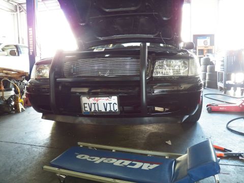 2003 Ford Crown Victoria - EVIL VIC Crown Victoria front end framed by an ACDelco creeper pad on the shop floor