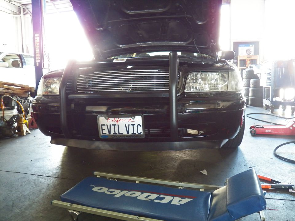 Black Crown Victoria front with brush guard, EVIL VIC plate, ACDelco creeper in foreground