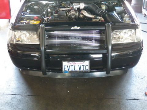 2003 Ford Crown Victoria - Close front shot showing billet grille, brush guard and a CROWN VICTORIA plate frame around EVIL VIC.