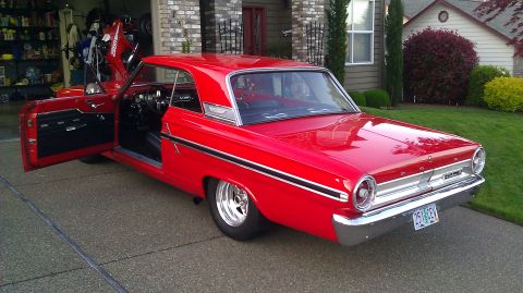 1964 Ford Fairlane - A bright red 1964 Ford Fairlane is shown with its doors and hood open, parked in a driveway in front of a house.