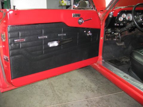 1964 Ford Fairlane - The interior of a classic car, focusing on the driver's side door panel and dashboard instruments.