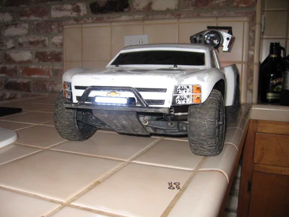 White remote control truck with a light bar on the bumper