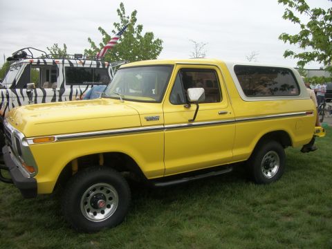 1996 Ford Bronco - This yellow Ford Bronco features a white removable top and chrome trim.