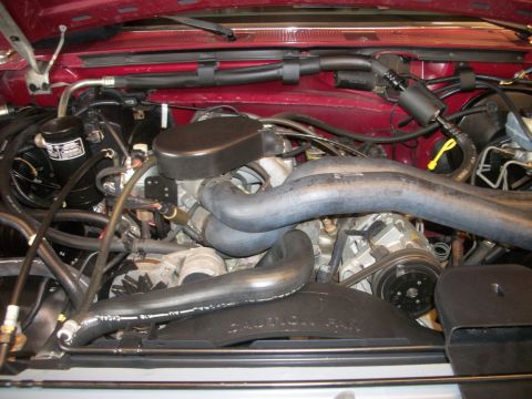 1996 Ford Bronco - Close-up view of an engine bay, showing various mechanical components and hoses.